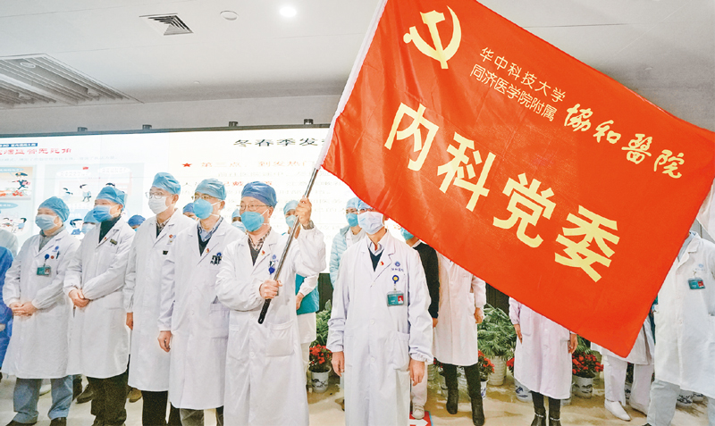 2020年1月22日，华中科技大学同济医学院附属协和医院内科30余名医务人员组成抗击新冠肺炎突击队，投入到协和医院对口支持的发热定点医院——武汉红十字会医院的工作中去。图为医务人员宣誓成立突击队。　新华社记者　程敏／摄